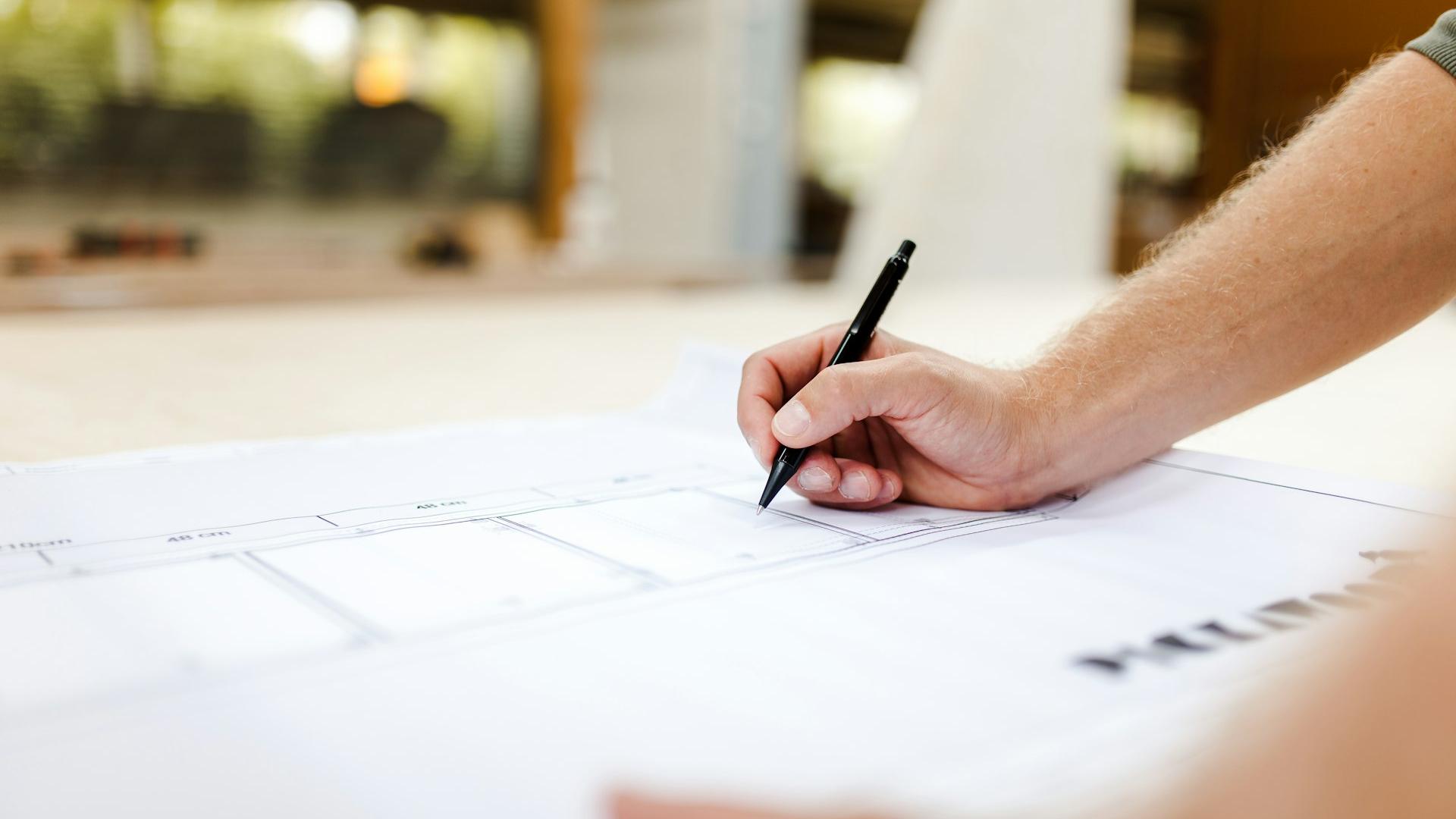 person writing on white paper