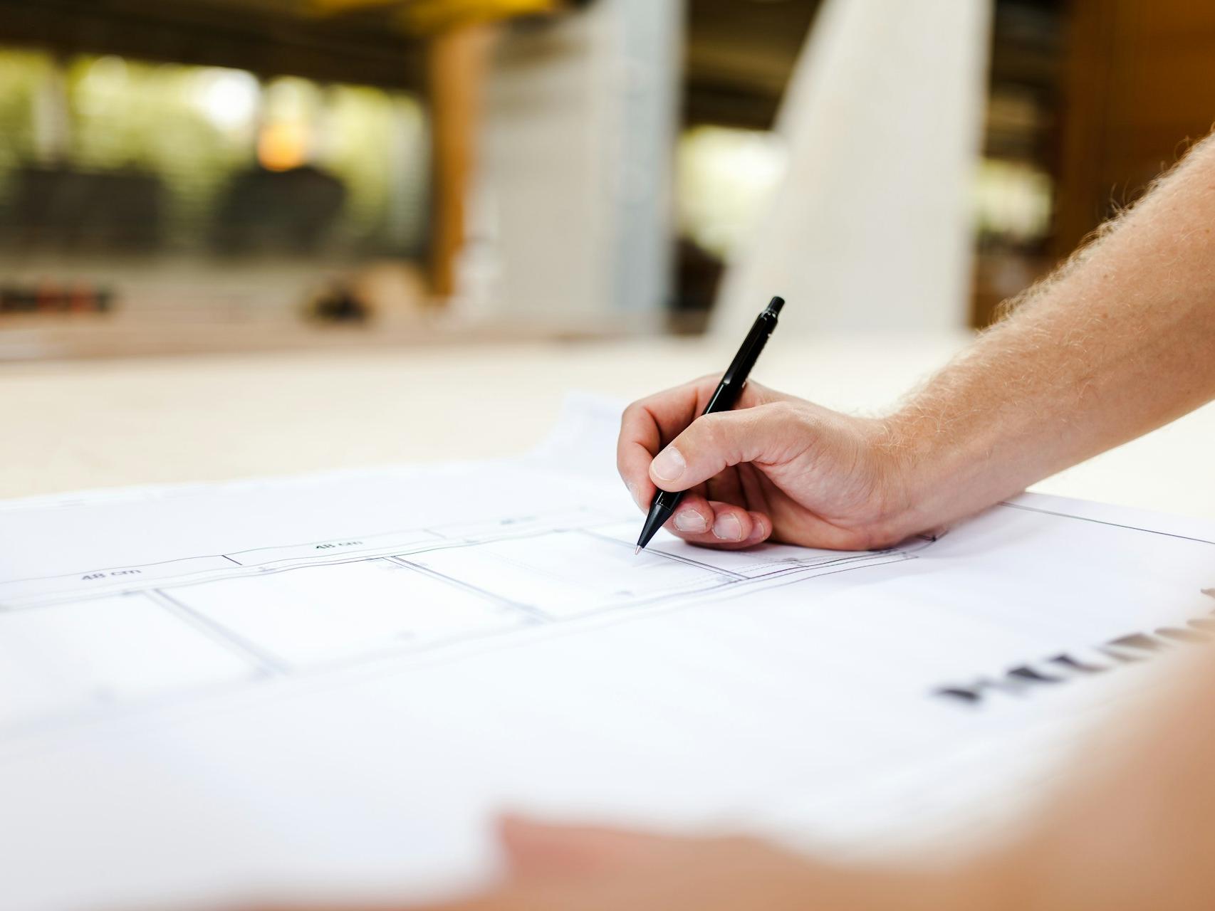 person writing on white paper